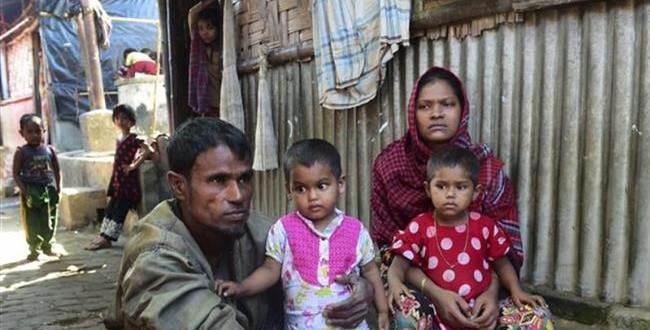A Rohingya couple whose two elder sons were taken by the Myanmarese military pose for a photograph with their younger children after their escape from Myanmar, in a refugee camp in Teknaf, in Bangladesh, November 24, 2016. (Photo by AFP)