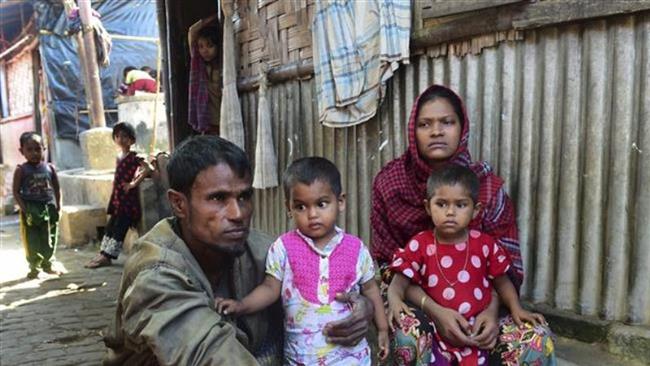 A Rohingya couple whose two elder sons were taken by the Myanmarese military pose for a photograph with their younger children after their escape from Myanmar, in a refugee camp in Teknaf, in Bangladesh, November 24, 2016. (Photo by AFP)